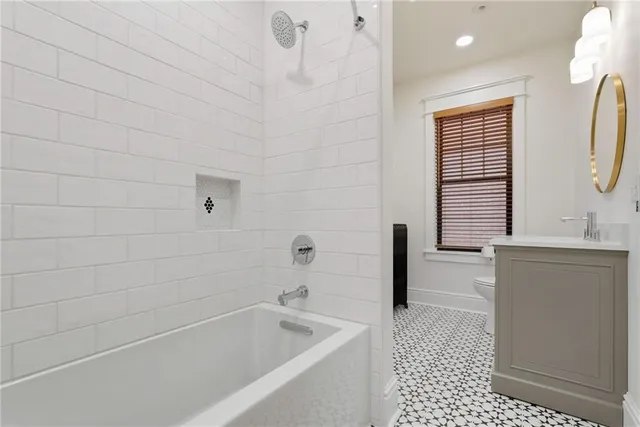 a bathroom with a bathtub a sink a toilet and a window