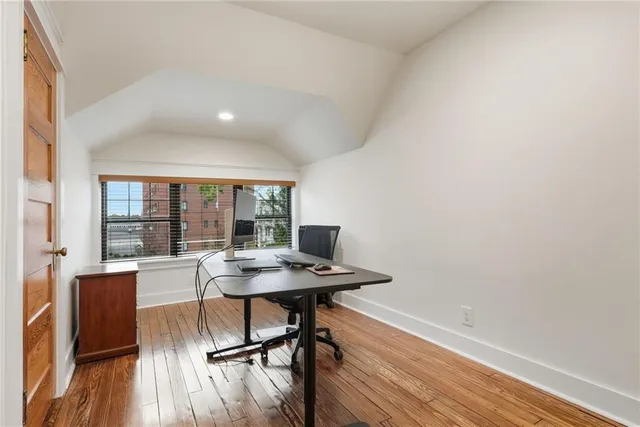 a view of a workspace with furniture and wooden floor