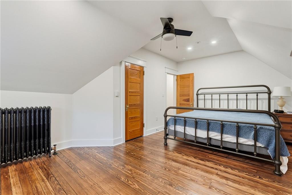 4749 Wallingford Street Pittsburgh, PA 15213 - Photo 42 of 49 a bedroom with a bed and wooden floor