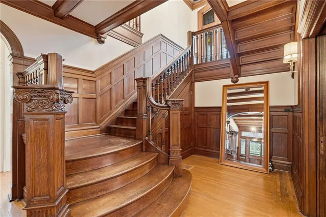 a view of entryway and hall with wooden floor