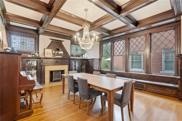 a dining room with furniture a fireplace and a chandelier
