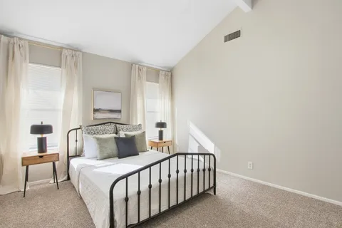 a bedroom with a bed and a night stand