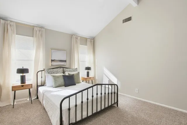 a bedroom with a bed and a night stand