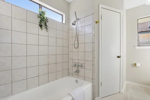 a bathroom with a bathtub and shower