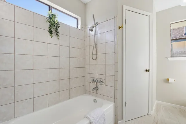 a bathroom with a bathtub and shower