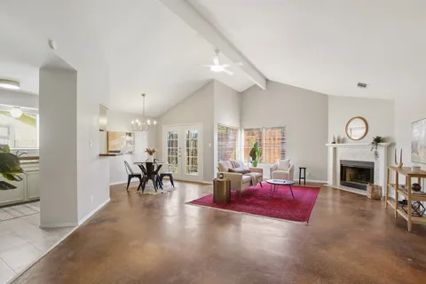 a living room with furniture large window and a fireplace
