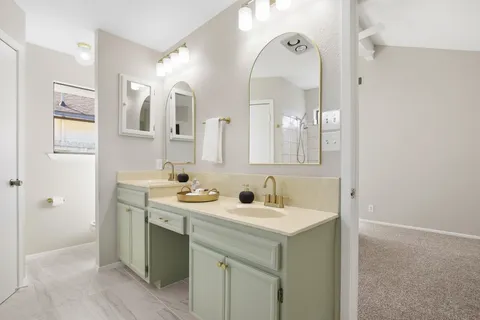 a bathroom with a double vanity sink mirror and
