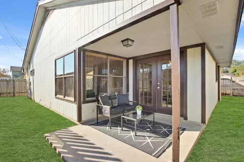 a living room with a table tennis table and chairs