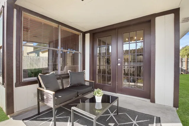 a living room with furniture and windows