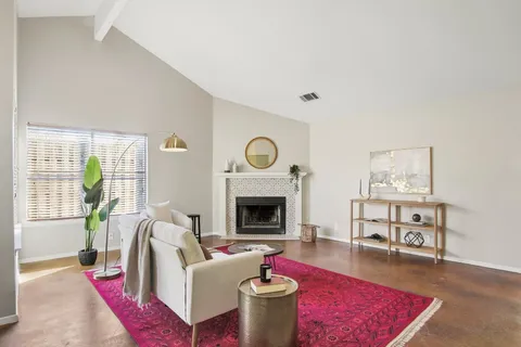a living room with furniture a rug and a fireplace
