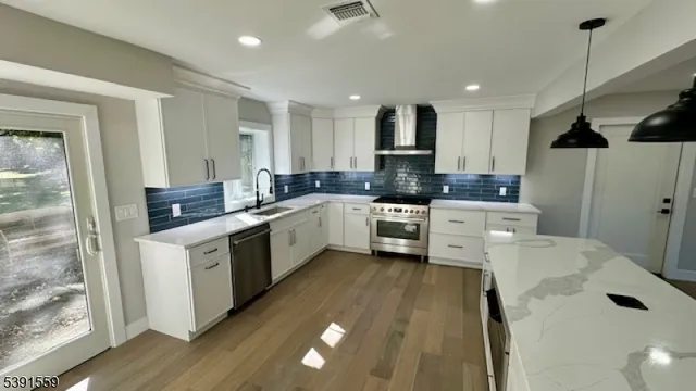 a kitchen with a sink a stove a refrigerator and cabinets