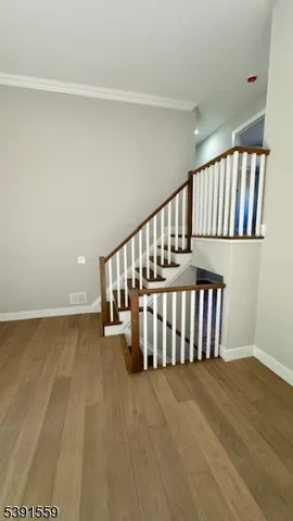 a view of staircase with white walls and a window