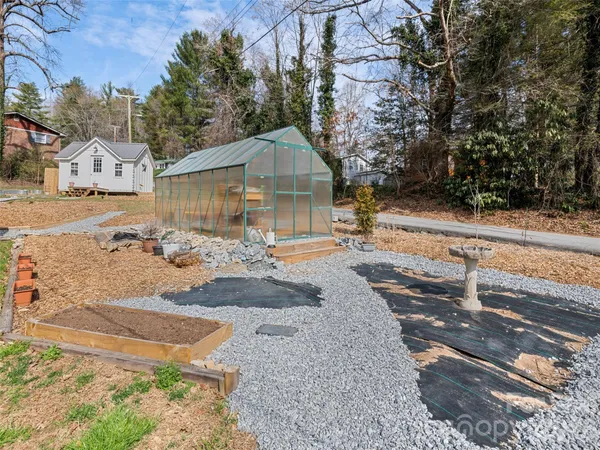 an aerial view of a house with swimming pool and porch
