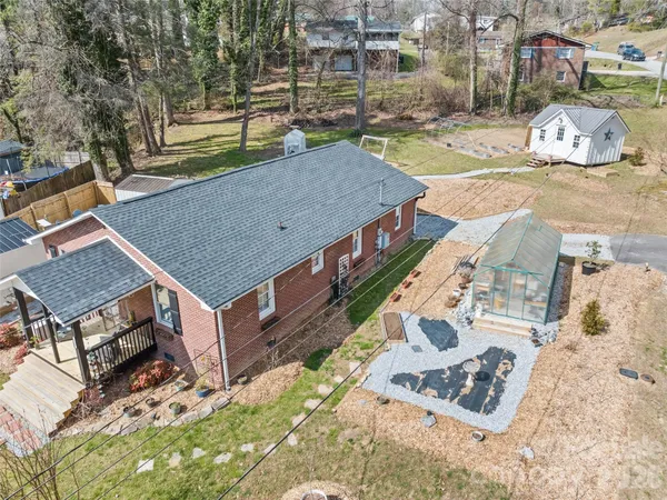 an aerial view of a house with a yard
