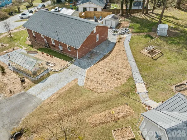 a backyard of a house with a yard and outdoor seating