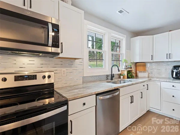 a view of a kitchen that has a lot of cabinets in it