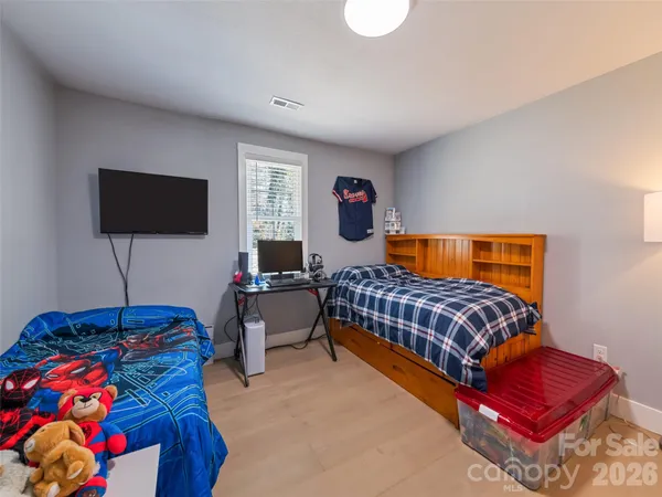 a bedroom with a bed and a potted plant