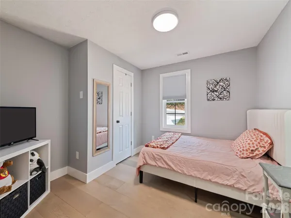 a bedroom with a bed and window