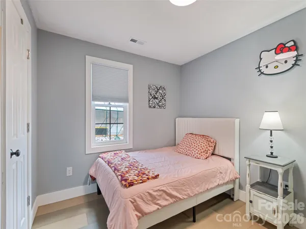 a bedroom with a bed and a lamp