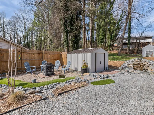 a view of a yard with a house in the background