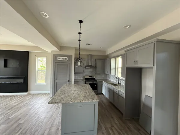 a kitchen with a stove a refrigerator and a sink