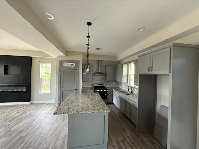 a kitchen with a stove a refrigerator and a sink