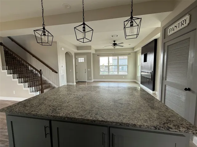 a view of a kitchen with a sink and wooden floor