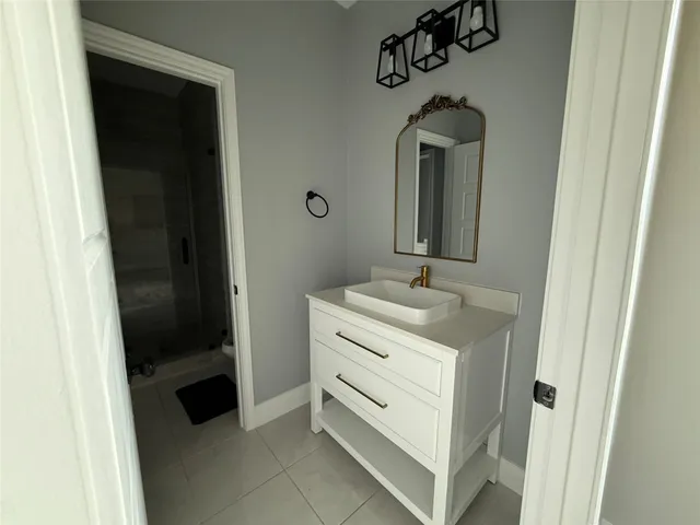 a bathroom with a sink and a mirror