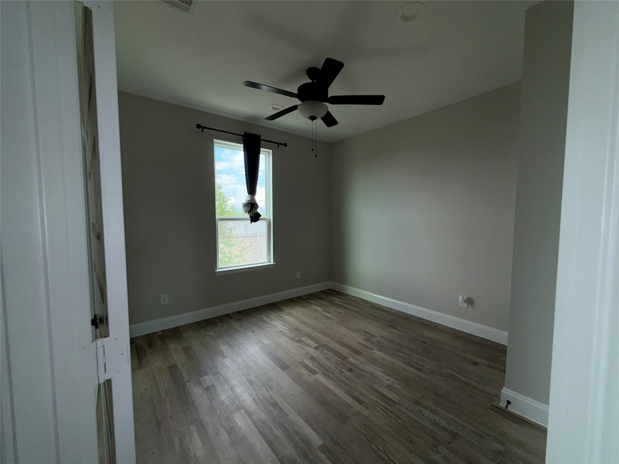 217 Kalmer Street Pasadena, TX 77502 - Photo 25 of 30 a view of an empty room with wooden floor and a window