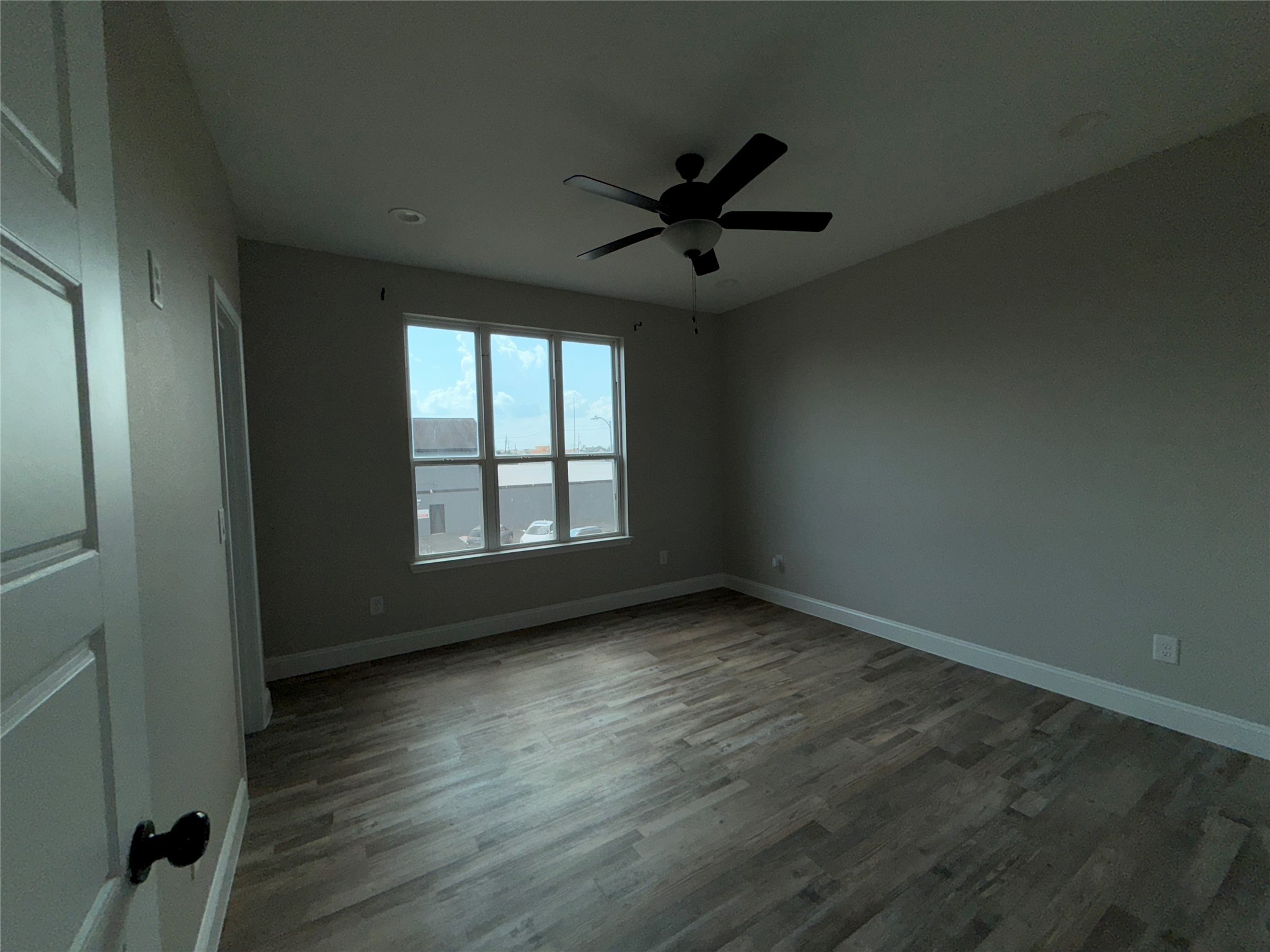 217 Kalmer Street Pasadena, TX 77502 - Photo 26 of 30 an empty room with wooden floor fan and windows