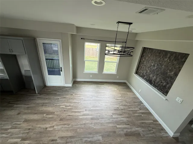 a view of a room with window and wooden floor