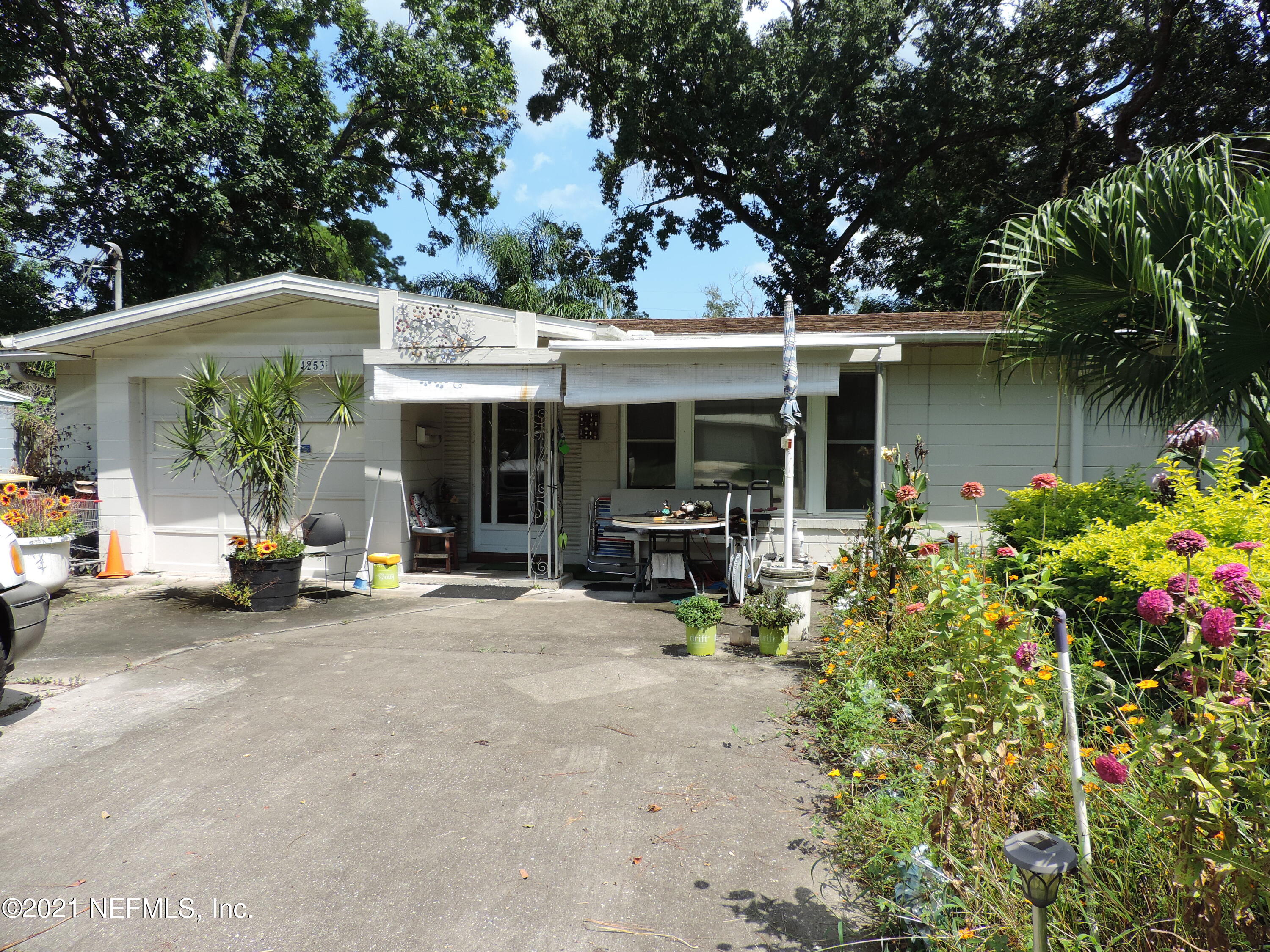 4253 Springwood Road Jacksonville, FL 32207 - Photo 1 of 16 a view of a patio with table and chairs under an umbrella