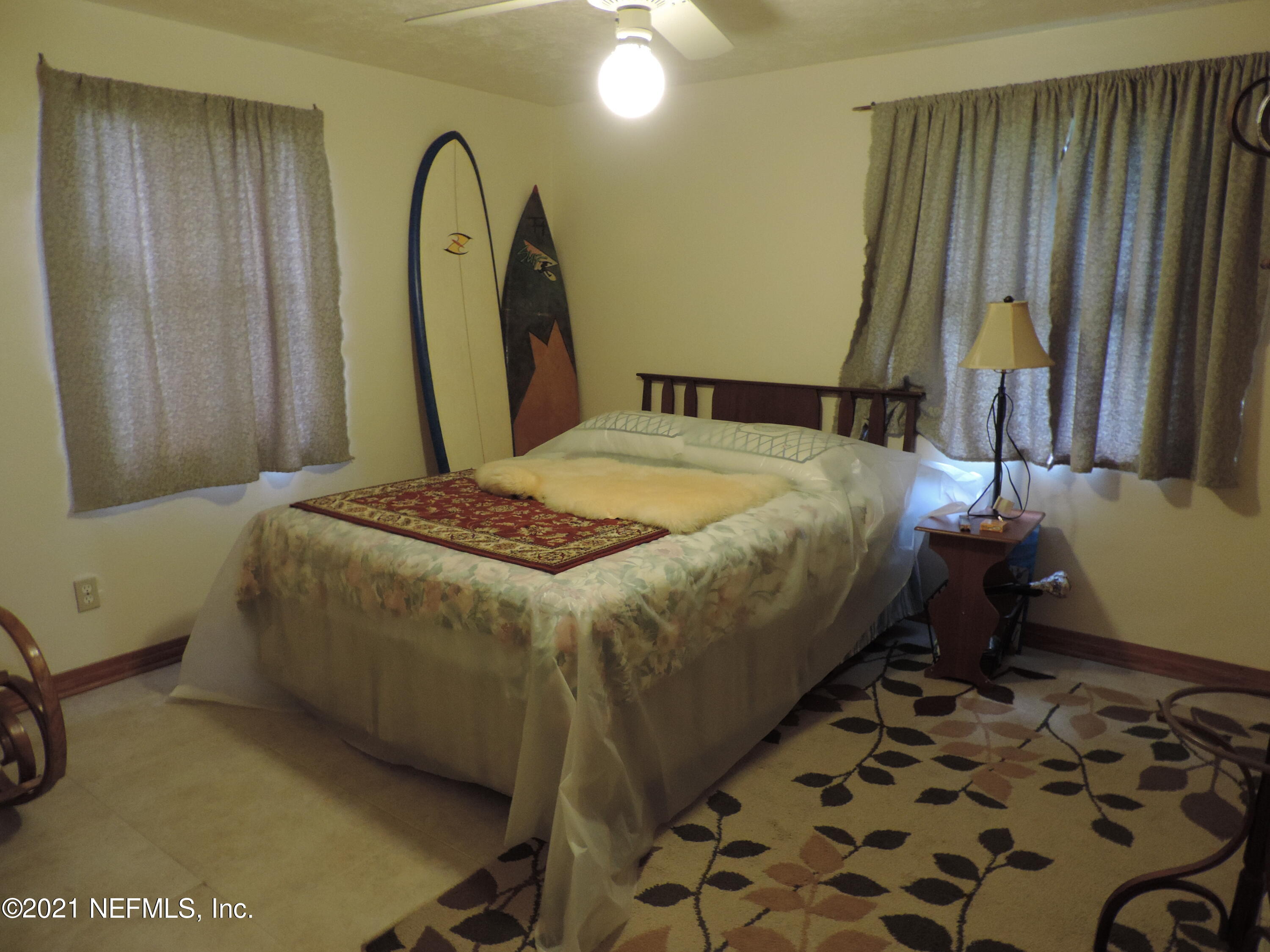 4253 Springwood Road Jacksonville, FL 32207 - Photo 11 of 16 a bed sitting in a bedroom next to a window