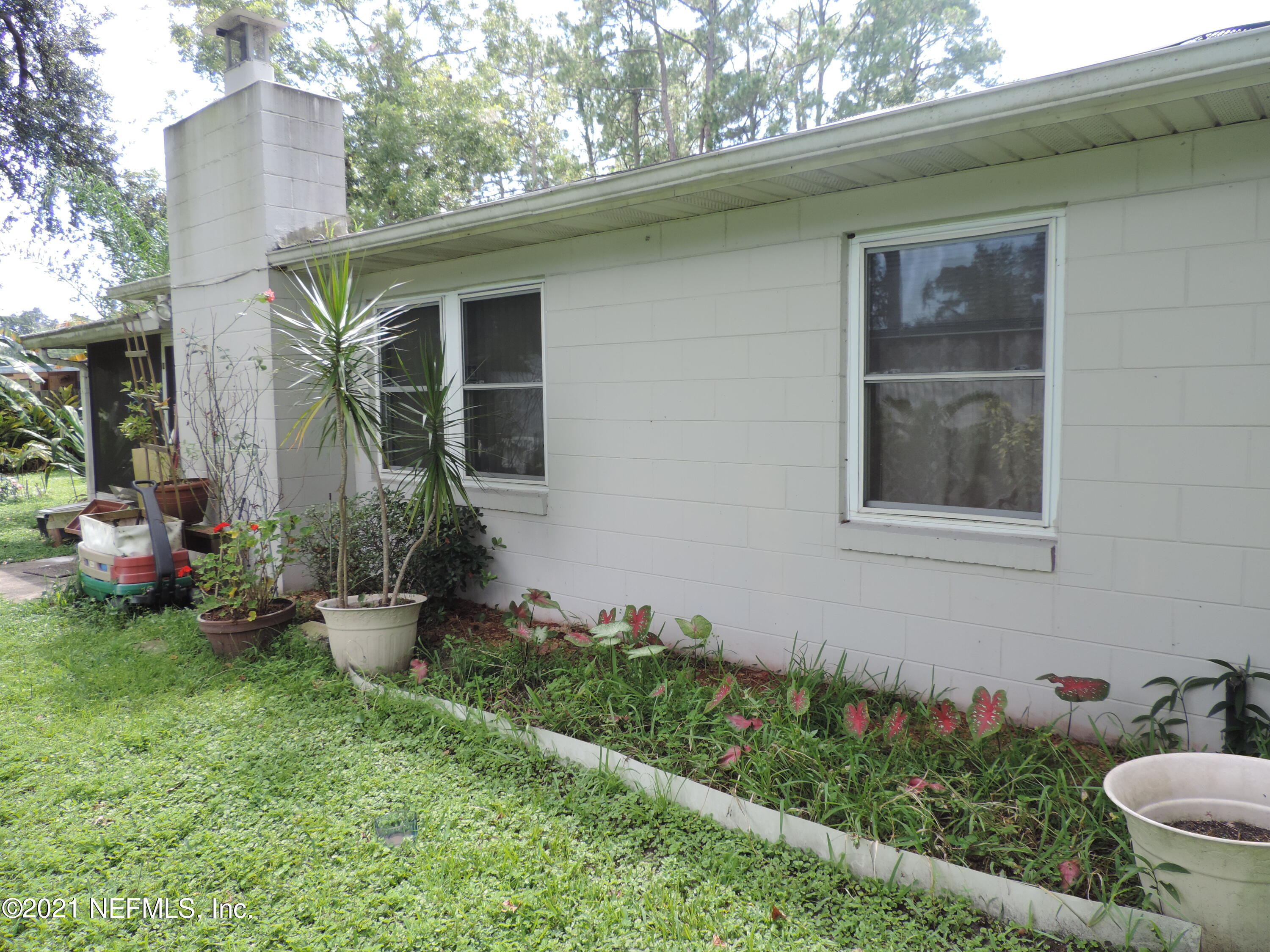 4253 Springwood Road Jacksonville, FL 32207 - Photo 14 of 16 a view of a house with backyard sitting area and garden