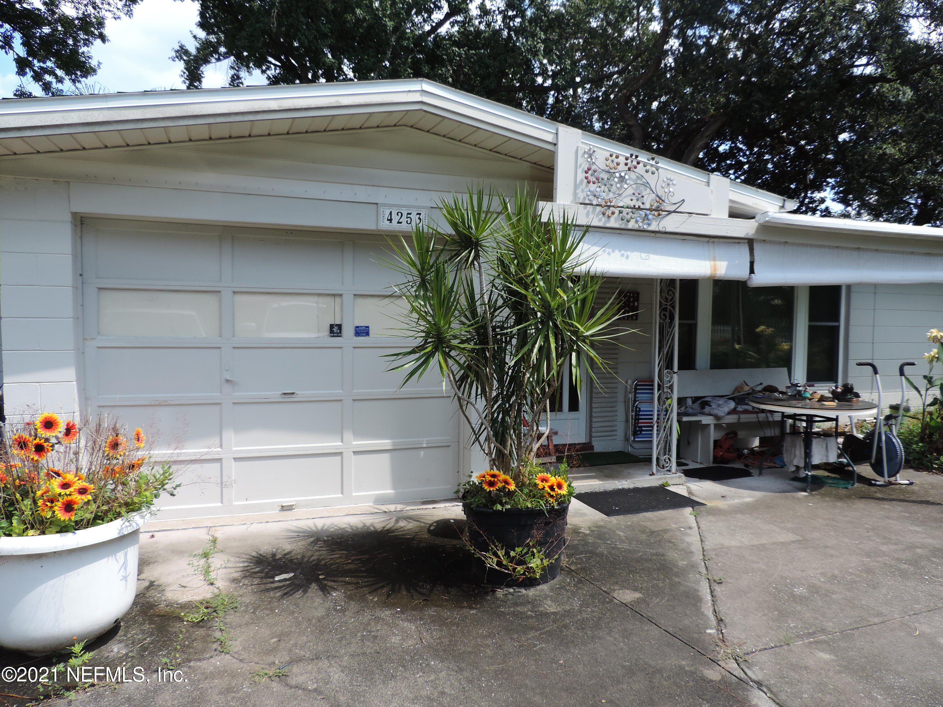 4253 Springwood Road Jacksonville, FL 32207 - Photo 2 of 16 a view of a patio with table and chairs potted plants