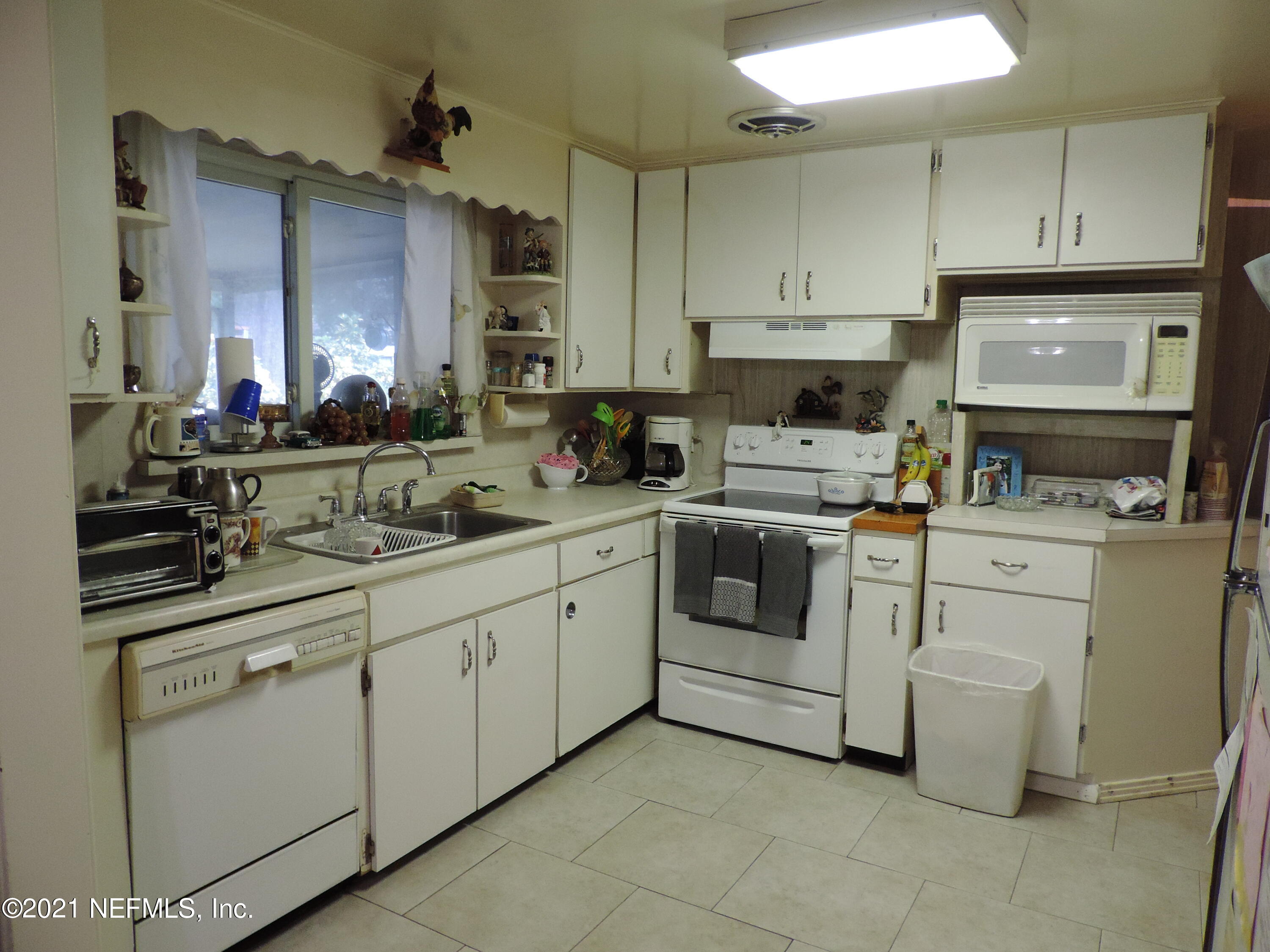 4253 Springwood Road Jacksonville, FL 32207 - Photo 7 of 16 a kitchen with cabinets appliances and a sink