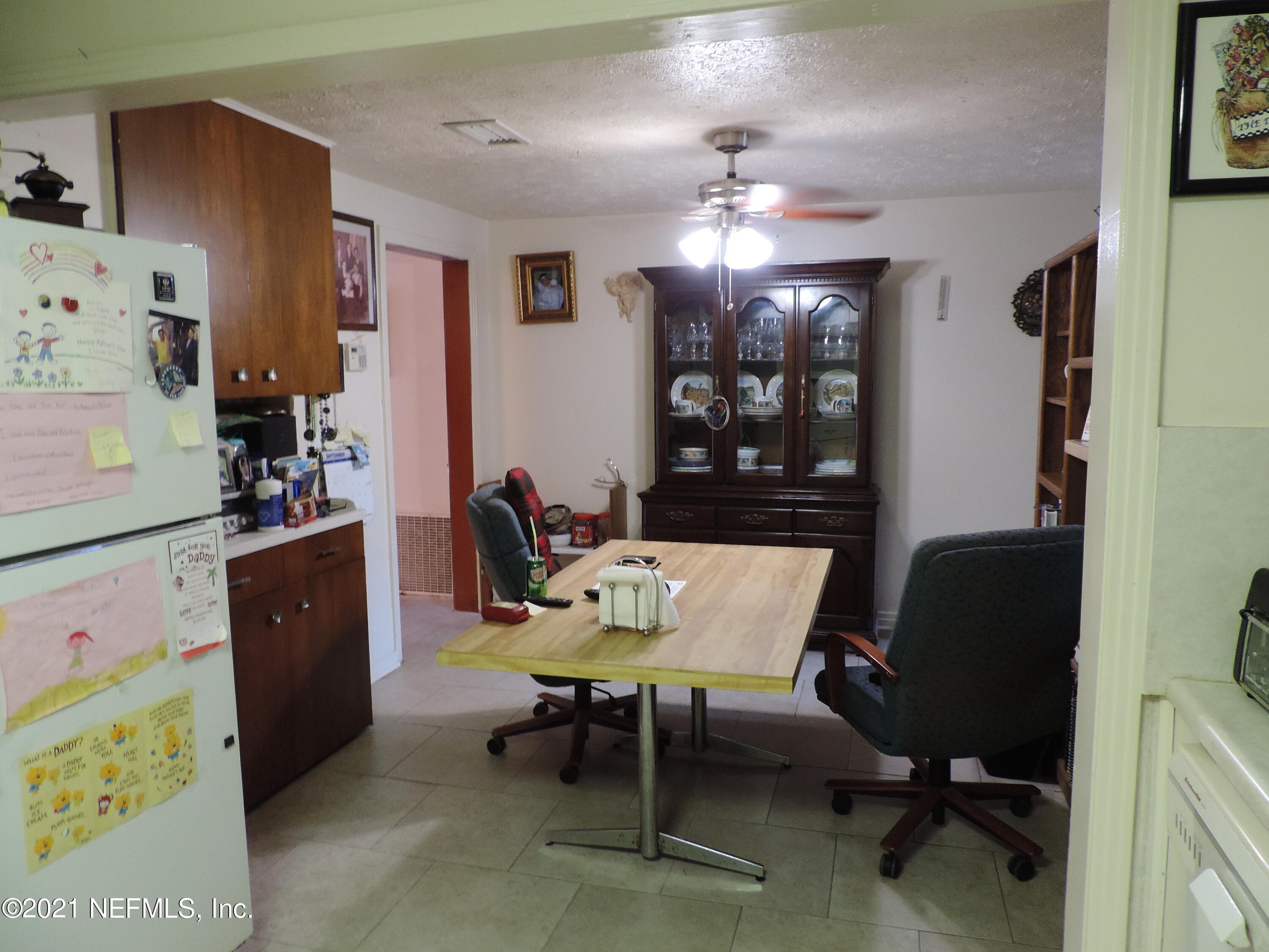 4253 Springwood Road Jacksonville, FL 32207 - Photo 8 of 16 a living room with furniture and a chandelier
