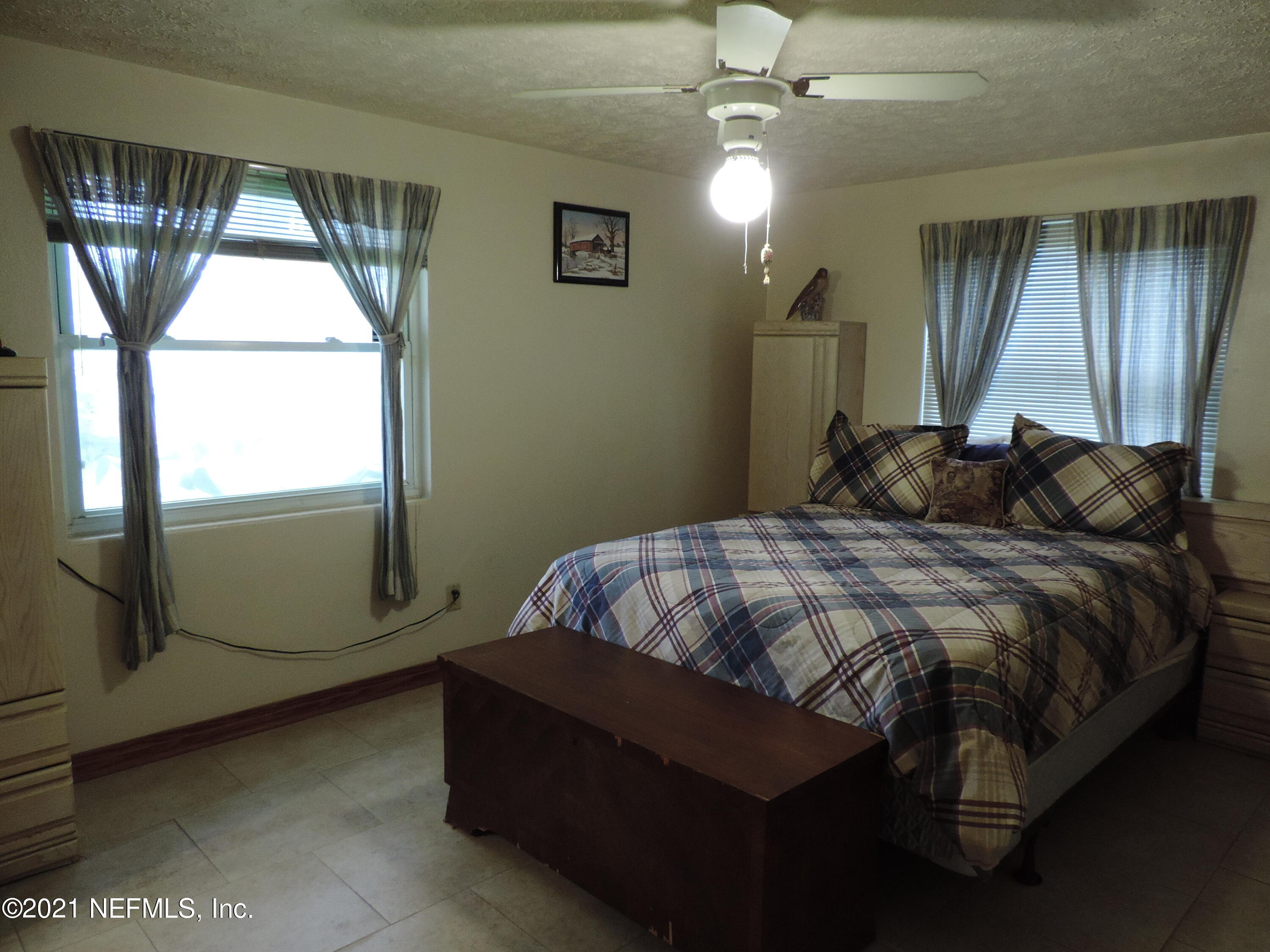 4253 Springwood Road Jacksonville, FL 32207 - Photo 10 of 16 a bedroom with a bed and window