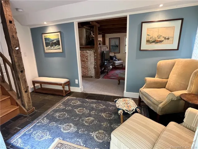 a bedroom with furniture and a rug