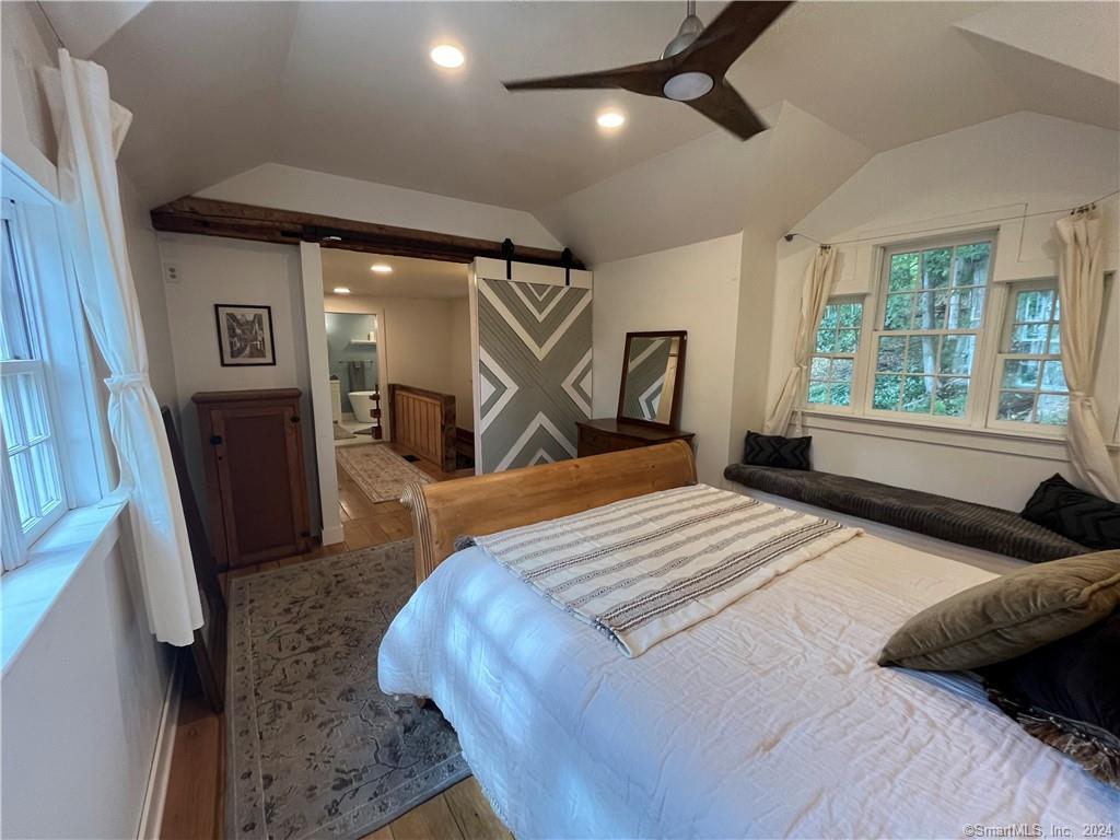 15 Riverview Road New Milford, CT 06755 - Photo 21 of 40 a bedroom with a bed next to a large window with wooden floor