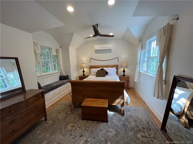 a bedroom with furniture and a flat screen tv