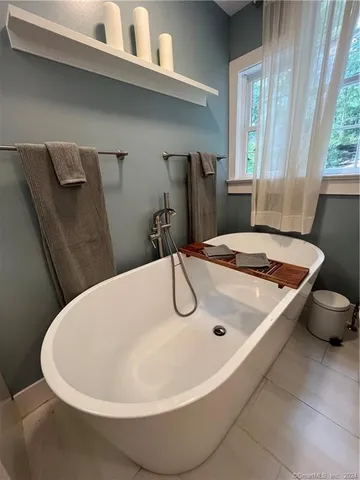 a white bath tub sitting in a bathroom