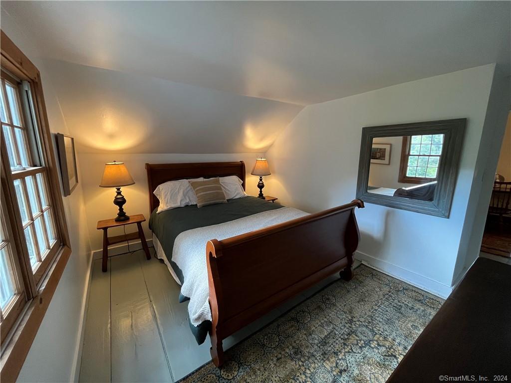 15 Riverview Road New Milford, CT 06755 - Photo 30 of 40 a bedroom with a bed and a mirror on dresser