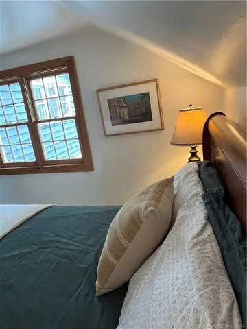 a bed sitting in a bedroom next to a window
