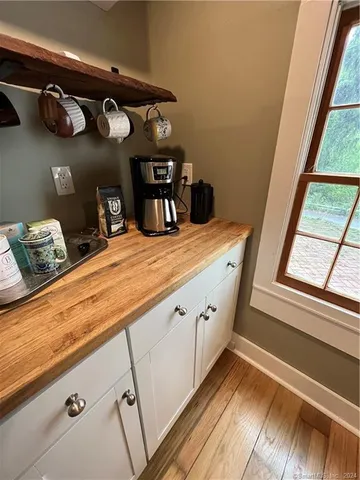 a view of kitchen with cabinets and a wooden floor