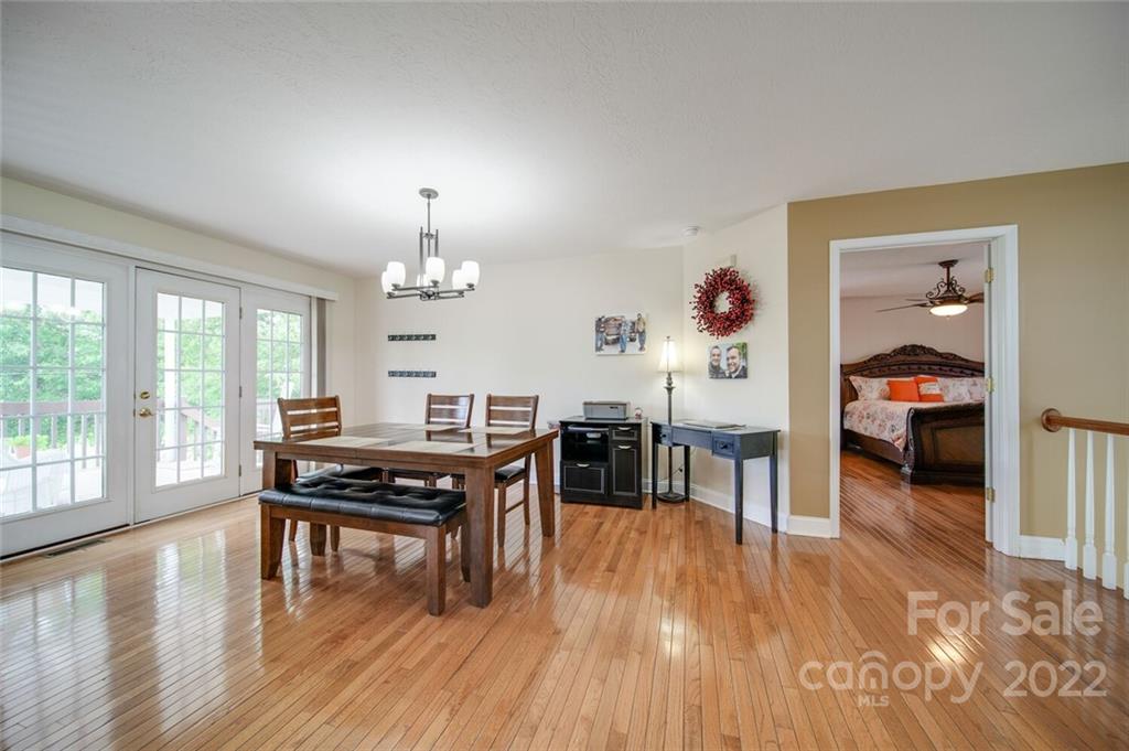 618 Goble Road Hiddenite, NC 28636 - Photo 11 of 46 a view of a dining room with furniture window and wooden floor