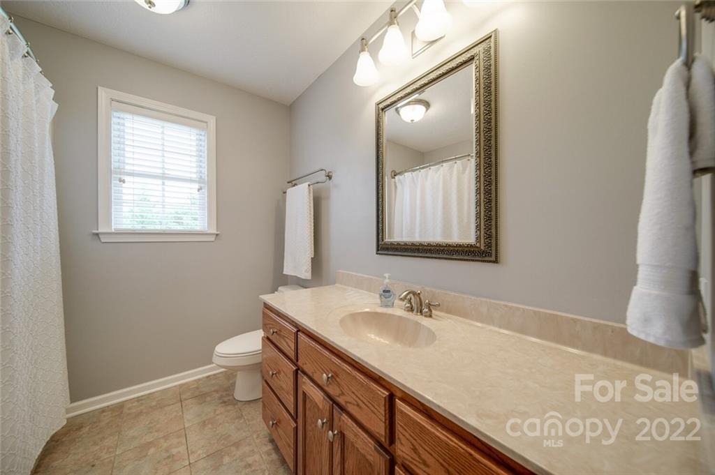 618 Goble Road Hiddenite, NC 28636 - Photo 20 of 46 a bathroom with a granite countertop sink toilet and mirror