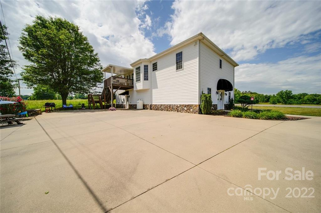 618 Goble Road Hiddenite, NC 28636 - Photo 41 of 46 a view of a house with a yard and potted plants
