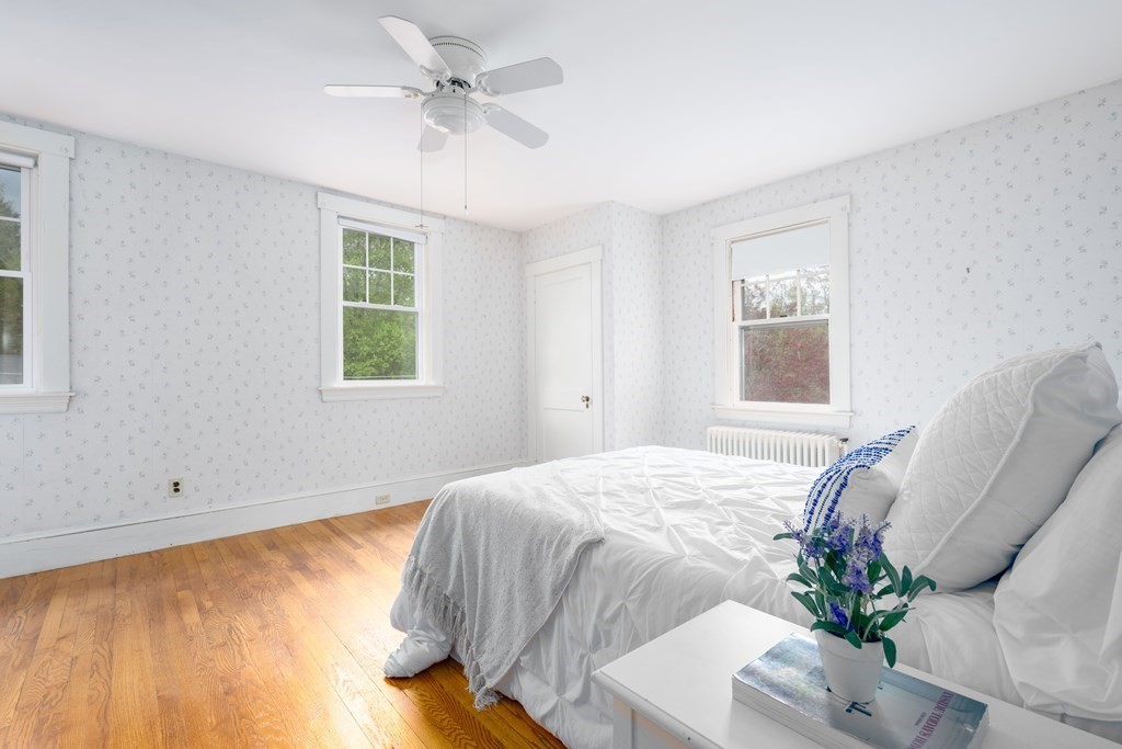 34 Brook Road Sharon, MA 02067 - Photo 12 of 19 a bedroom with a bed and a chandelier