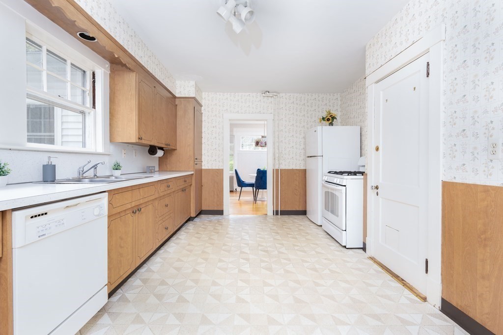 34 Brook Road Sharon, MA 02067 - Photo 9 of 19 a large white kitchen with cabinets and white appliances